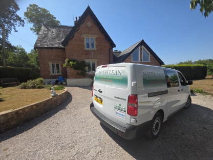 Masterclean carpet and upholstery cleaning van outside a beautiful home in Devon